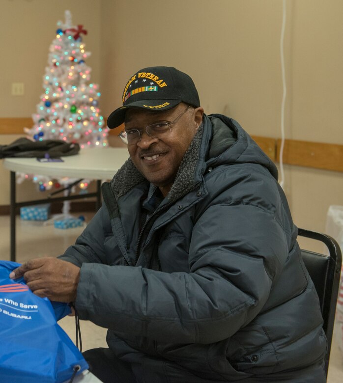 Clinton Jones, Offutt Advisory Council, fills holiday cheer bags Dec. 10, 2019. Members of the Bellevue Chamber of Commerce and Offutt Air Force Base leadership filled holiday cheer bags for dorm residents here.