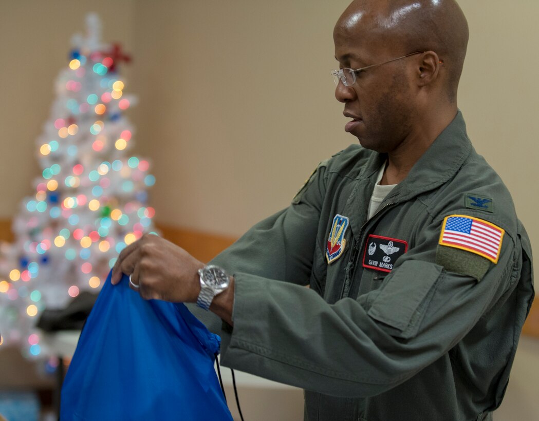 Col. Gavin Marks, 55th Wing commander, fills holiday cheer bags Dec. 10, 2019. Members of the Bellevue Chamber of Commerce and Offutt Air Force Base leadership filled holiday cheer bags for dorm residents here.