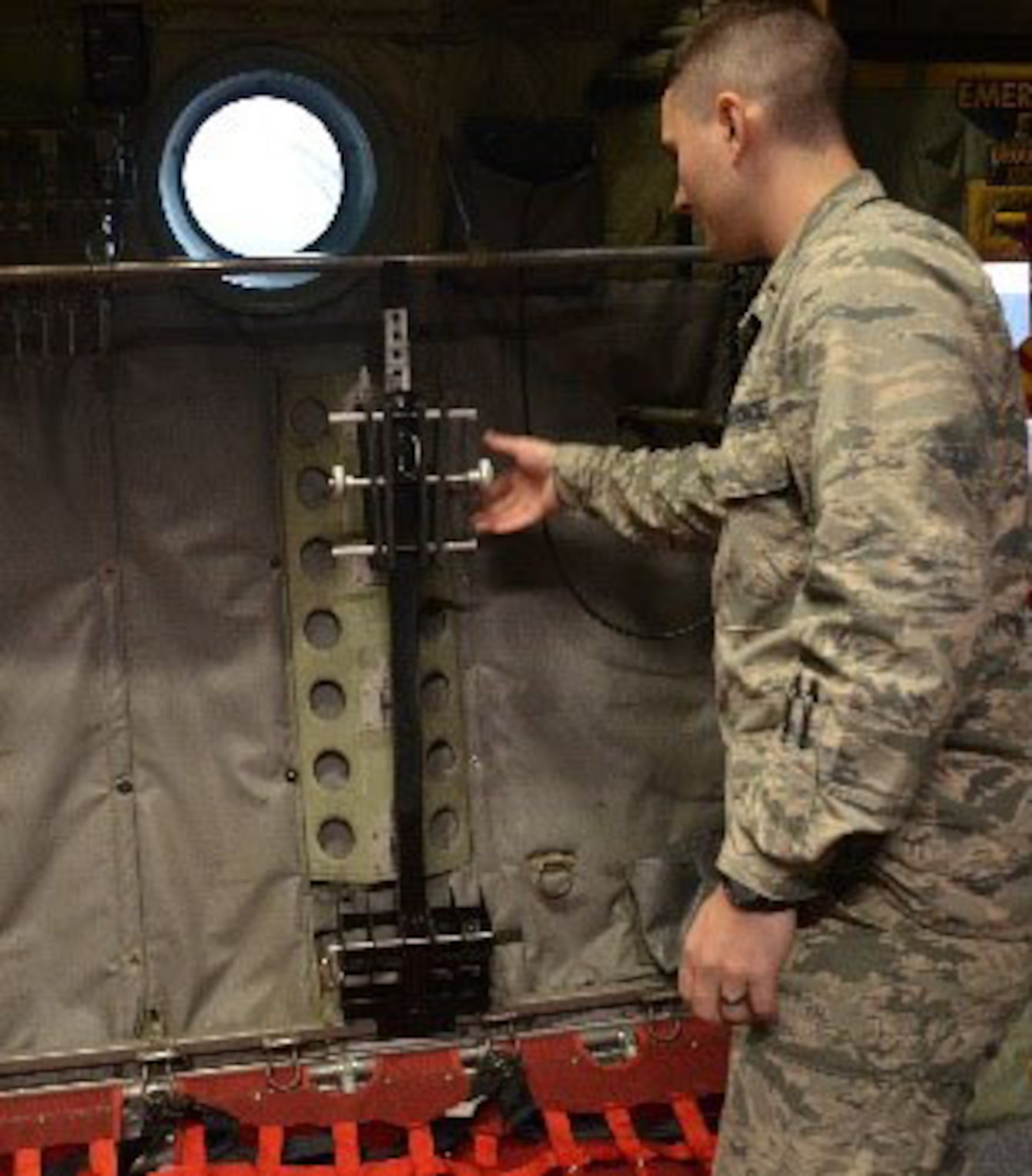 2nd Lt. Alexander Orsi of the Air Force Research Laboratory’s Junior Force Warfighter Operations team displays the rack prototype aboard a C-130 aircraft. (U.S. Air Force photo/Donna Lindner)