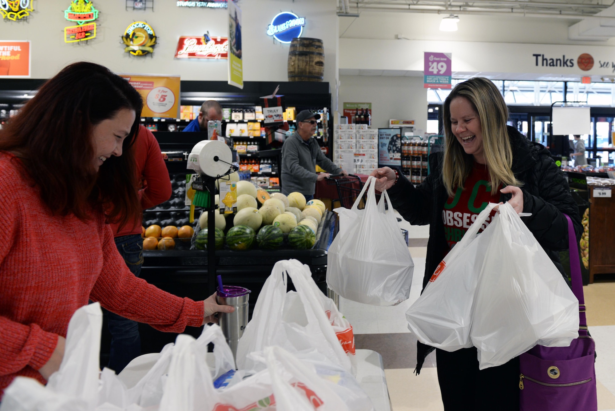 Lynell Rice Brinkworth, a shopper at the Family Fare Super Market in Rapid City, S.D., donates cookies to Jennifer Bassett, the Ellsworth Spouse’s Club Socials chairperson, Dec. 7, 2019. During the fundraiser, community members donated either pre-packaged cookies or provided a monetary donation for the Ellsworth Air Force Base Cookie Drive, an annual event for dormitory Airmen during the holidays. (U.S. Air Force photo by Airman Quentin K. Marx)