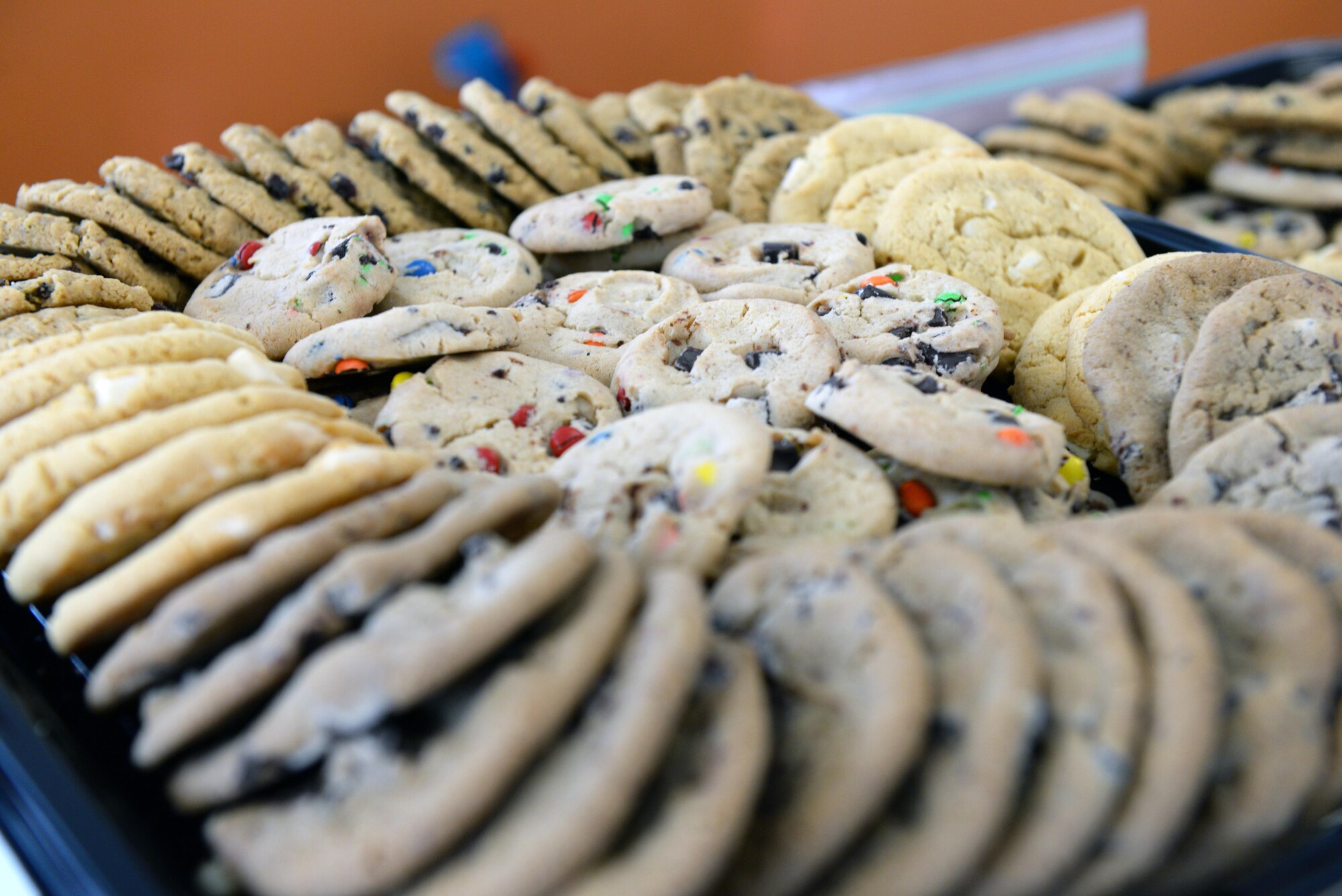 The Ellsworth Spouse’s Club arranges homemade and store-bought cookies for the Cookie Drive at Ellsworth Air Force Base, S.D., Dec. 9, 2019. The Club received roughly $277 in monetary donations and packaged more than 12,000 cookies, spreading holiday cheer to more than 700 dormitory single Airmen. (U.S. Air Force photo by Airman Quentin K. Marx)