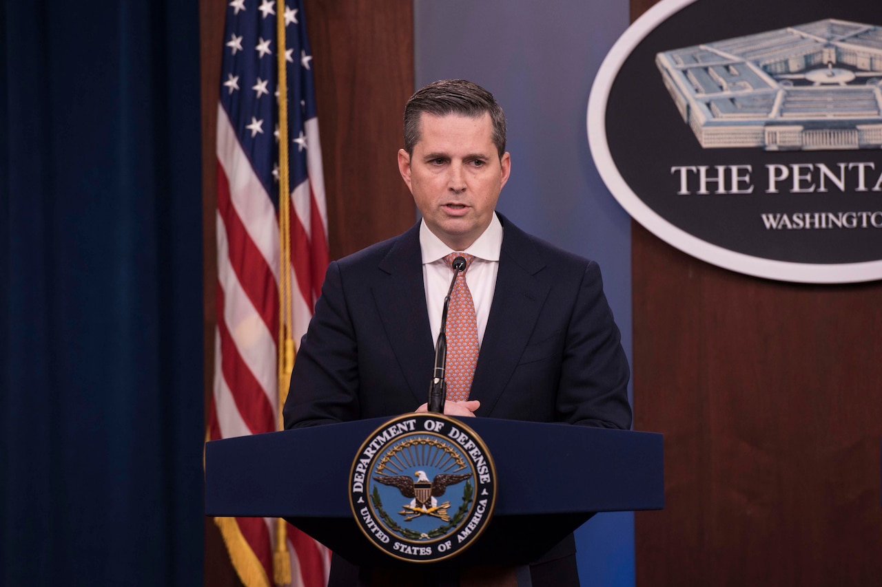 A man speaks from behind a podium.