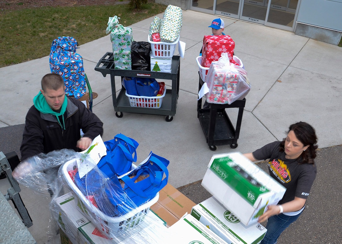 Three people move packages as seen from a high angle