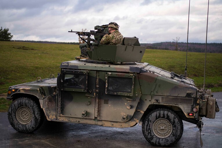 A soldier rides in a tank.