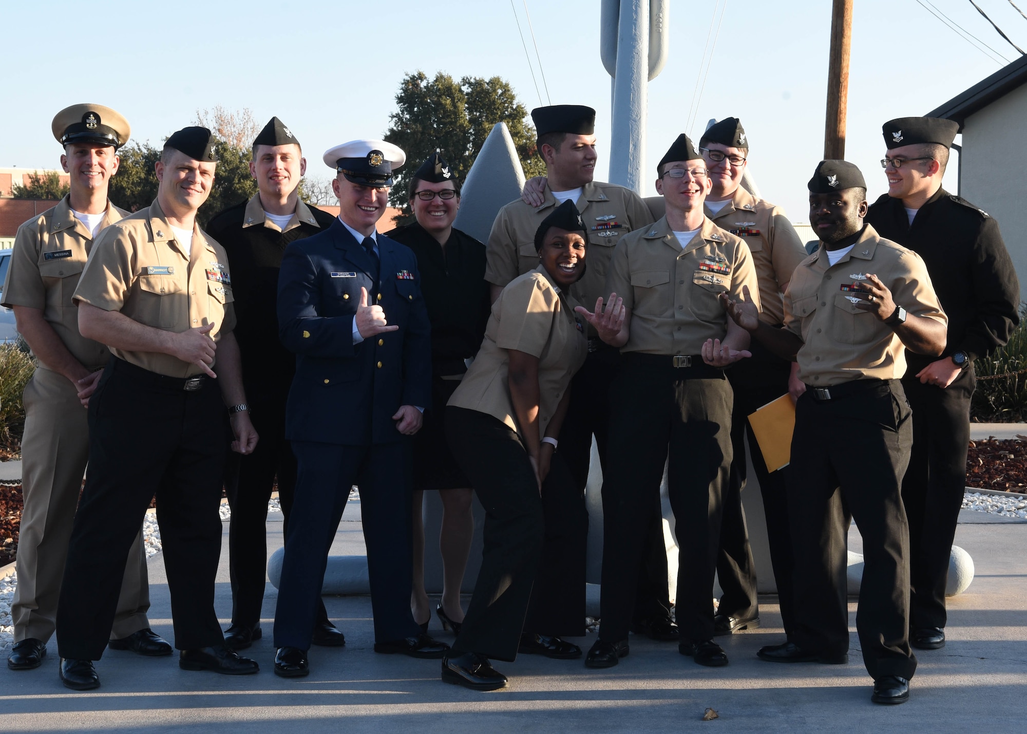 U.S. Navy Analysis and Reporting course graduates pose for a relaxed photo outside of the Center for Information Warfare Training Detachment on Goodfellow Air Force Base, Texas, Dec. 12, 2019. Goodfellow trains all military members in line of its Joint Force mission to develop professionals on behalf of the Department of Defense. (U.S. Air Force photo by Airman 1st Class Abbey Rieves)