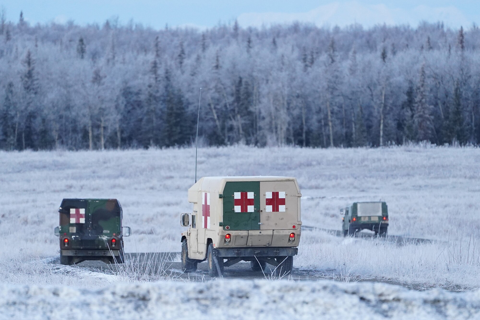 Army medics drive to their staging areas before paratroopers assigned to the 4th Infantry Brigade Combat Team (Airborne), 25th Infantry Division, U.S. Army Alaska, conduct a parachute jump on Malemute drop zone at Joint Base Elmendorf-Richardson, Alaska, Dec. 11, 2019. The Soldiers are part of the Army’s only Pacific airborne brigade with the ability to rapidly deploy worldwide, and are trained to conduct military operations in austere conditions.