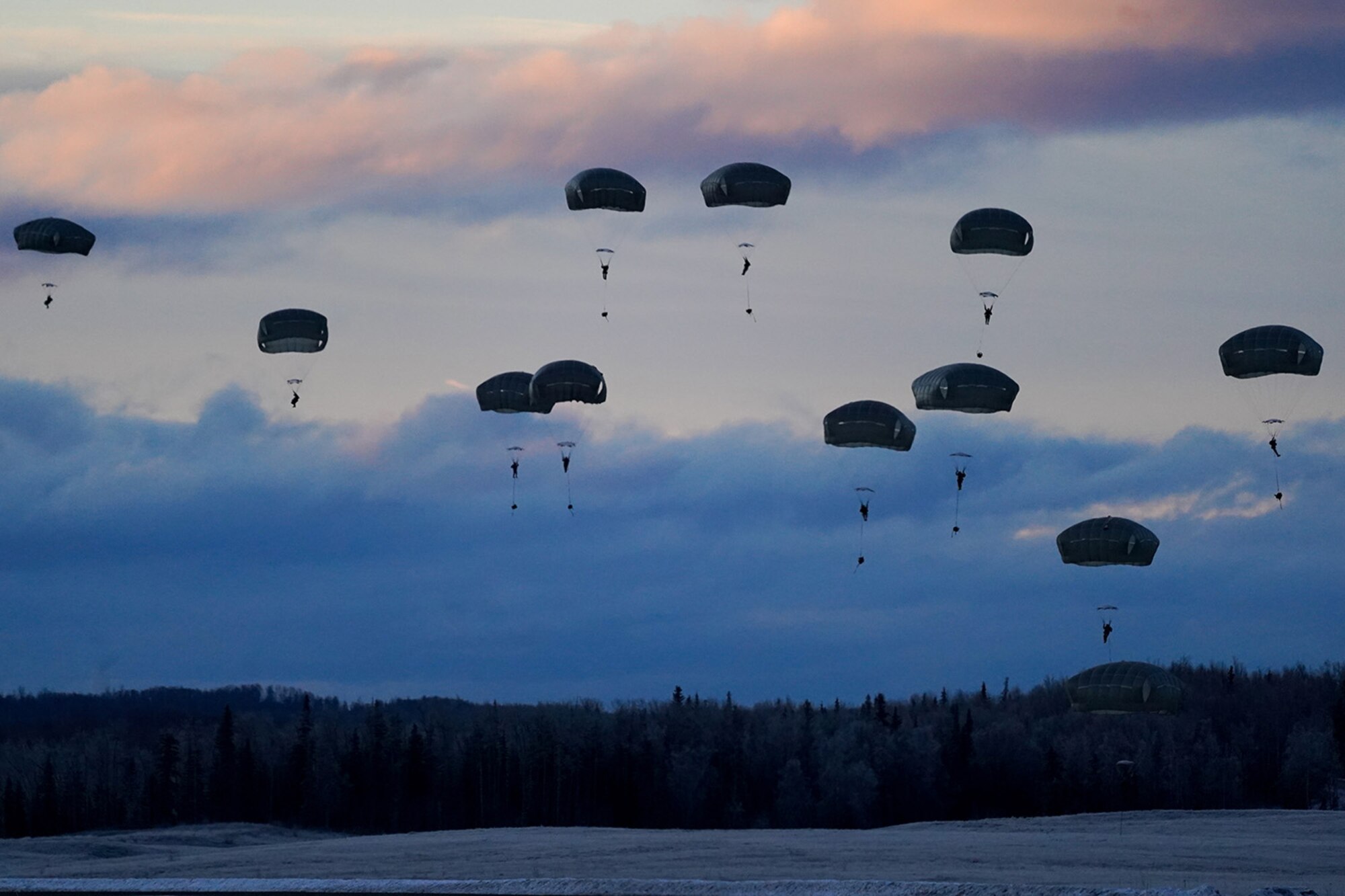 Paratroopers assigned to the 4th Infantry Brigade Combat Team (Airborne), 25th Infantry Division, U.S. Army Alaska, conduct a parachute jump on Malemute drop zone at Joint Base Elmendorf-Richardson, Alaska, Dec. 11, 2019. The Soldiers are part of the Army’s only Pacific airborne brigade with the ability to rapidly deploy worldwide, and are trained to conduct military operations in austere conditions.