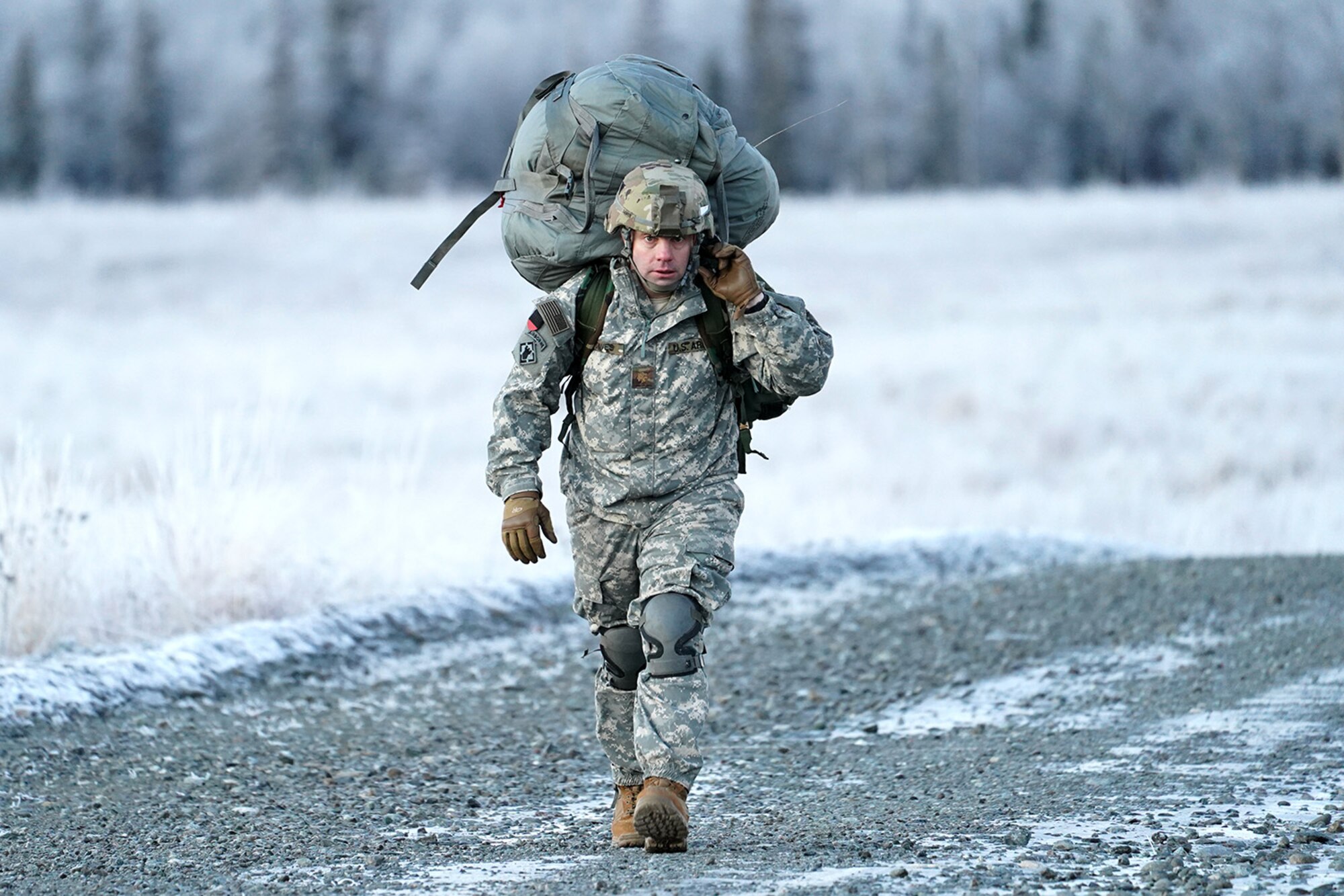 Army Maj. David Dawes, assigned to the 6th Brigade Engineer Battalion (Airborne), 4th Infantry Brigade Combat Team (Airborne), 25th Infantry Division, U.S. Army Alaska, makes his way to a rally point after conducting a parachute jump on Malemute drop zone at Joint Base Elmendorf-Richardson, Alaska, Dec. 11, 2019. The Soldiers are part of the Army’s only Pacific airborne brigade with the ability to rapidly deploy worldwide, and are trained to conduct military operations in austere conditions.