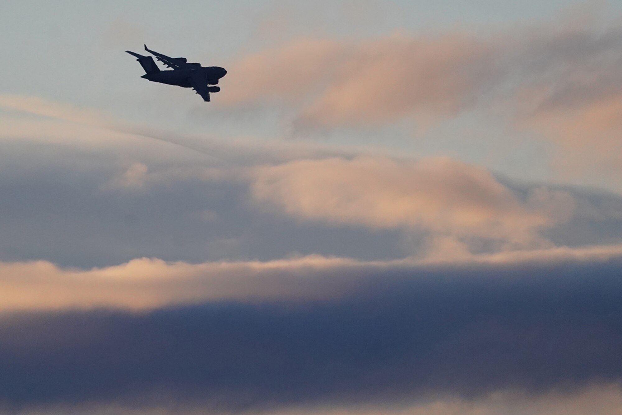 A C-17 Globemaster III banks in the early morning light after paratroopers assigned to the 4th Infantry Brigade Combat Team (Airborne), 25th Infantry Division, U.S. Army Alaska, conducted a parachute jump on Malemute drop zone at Joint Base Elmendorf-Richardson, Alaska, Dec. 11, 2019. The Soldiers are part of the Army’s only Pacific airborne brigade with the ability to rapidly deploy worldwide, and are trained to conduct military operations in austere conditions.