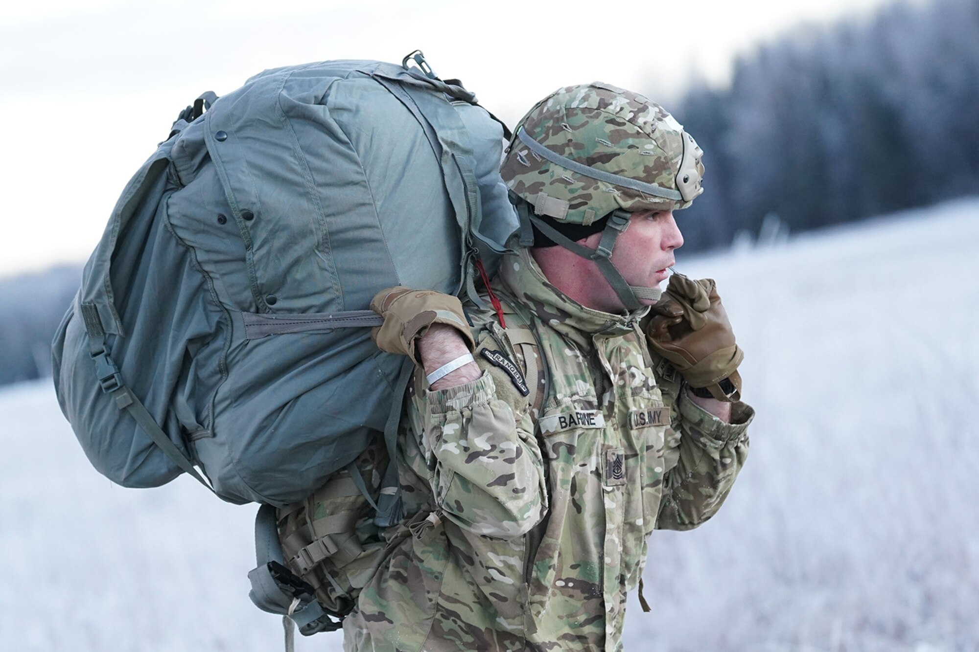 Army 1st Sgt. George Barbine, assigned to the 1st Battalion, 501st Parachute Infantry Regiment, 4th Infantry Brigade Combat Team (Airborne), 25th Infantry Division, U.S. Army Alaska, makes his way to a rally point after conducting a parachute jump on Malemute drop zone at Joint Base Elmendorf-Richardson, Alaska, Dec. 11, 2019. The Soldiers are part of the Army’s only Pacific airborne brigade with the ability to rapidly deploy worldwide, and are trained to conduct military operations in austere conditions.