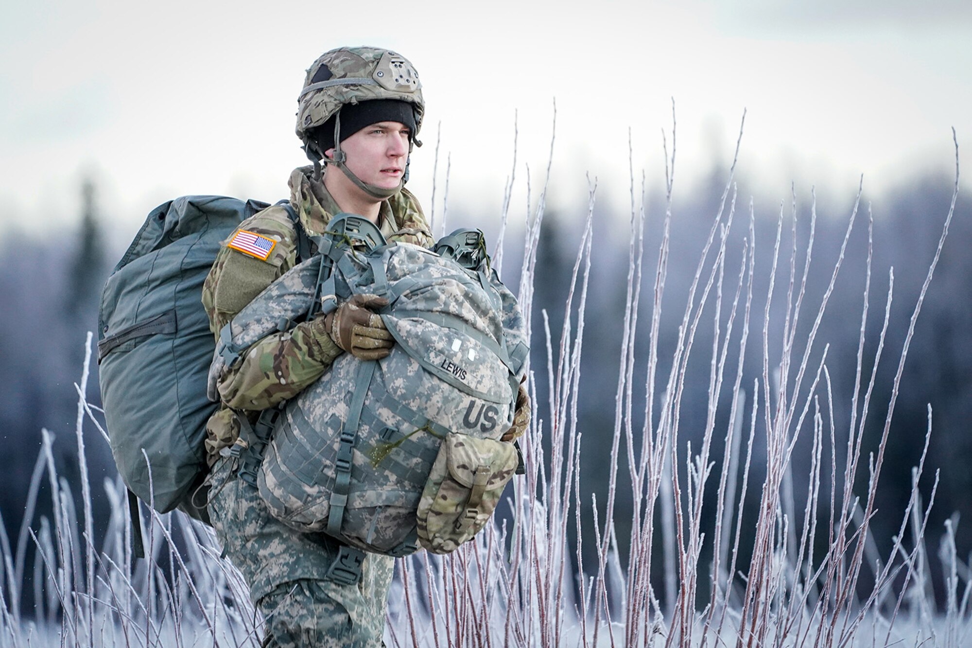Army Pfc. Rhett Lewis, assigned to the 1st Battalion, 501st Parachute Infantry Regiment, 4th Infantry Brigade Combat Team (Airborne), 25th Infantry Division, U.S. Army Alaska, makes his way to a rally point after conducting a parachute jump on Malemute drop zone at Joint Base Elmendorf-Richardson, Alaska, Dec. 11, 2019. The Soldiers are part of the Army’s only Pacific airborne brigade with the ability to rapidly deploy worldwide, and are trained to conduct military operations in austere conditions.
