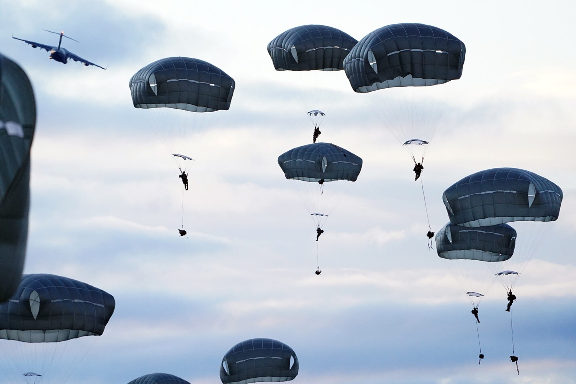Paratroopers assigned to the 4th Infantry Brigade Combat Team (Airborne), 25th Infantry Division, U.S. Army Alaska, conduct a parachute jump on Malemute drop zone at Joint Base Elmendorf-Richardson, Alaska, Dec. 11, 2019. The Soldiers are part of the Army’s only Pacific airborne brigade with the ability to rapidly deploy worldwide, and are trained to conduct military operations in austere conditions.