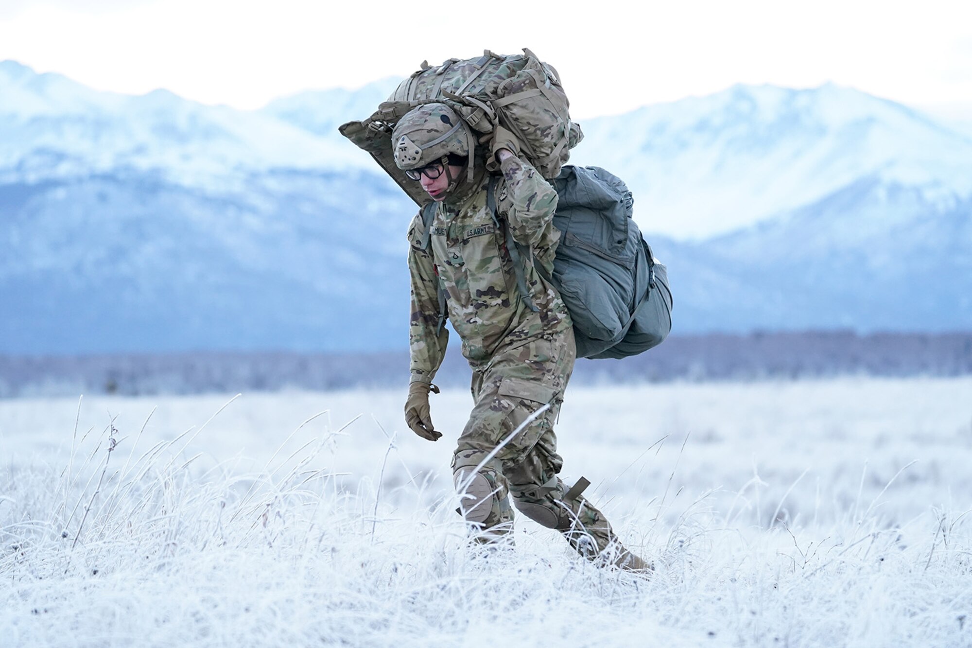 Army Pfc. Evan Samuel, assigned to the 2nd Battalion, 377th Parachute Field Artillery Regiment, 4th Infantry Brigade Combat Team (Airborne), 25th Infantry Division, U.S. Army Alaska, makes his way to a rally point after conducting a parachute jump on Malemute drop zone at Joint Base Elmendorf-Richardson, Alaska, Dec. 11, 2019. The Soldiers are part of the Army’s only Pacific airborne brigade with the ability to rapidly deploy worldwide, and are trained to conduct military operations in austere conditions.