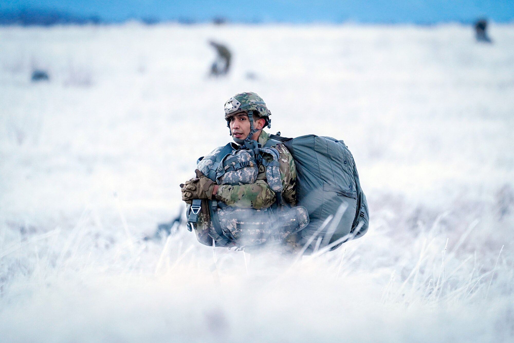 Army Pvt. Pedro Lara, assigned to the 6th Brigade Engineer Battalion (Airborne), 4th Infantry Brigade Combat Team (Airborne), 25th Infantry Division, U.S. Army Alaska, makes his way to a rally point after conducting a parachute jump on Malemute drop zone at Joint Base Elmendorf-Richardson, Alaska, Dec. 11, 2019. The Soldiers are part of the Army’s only Pacific airborne brigade with the ability to rapidly deploy worldwide, and are trained to conduct military operations in austere conditions.