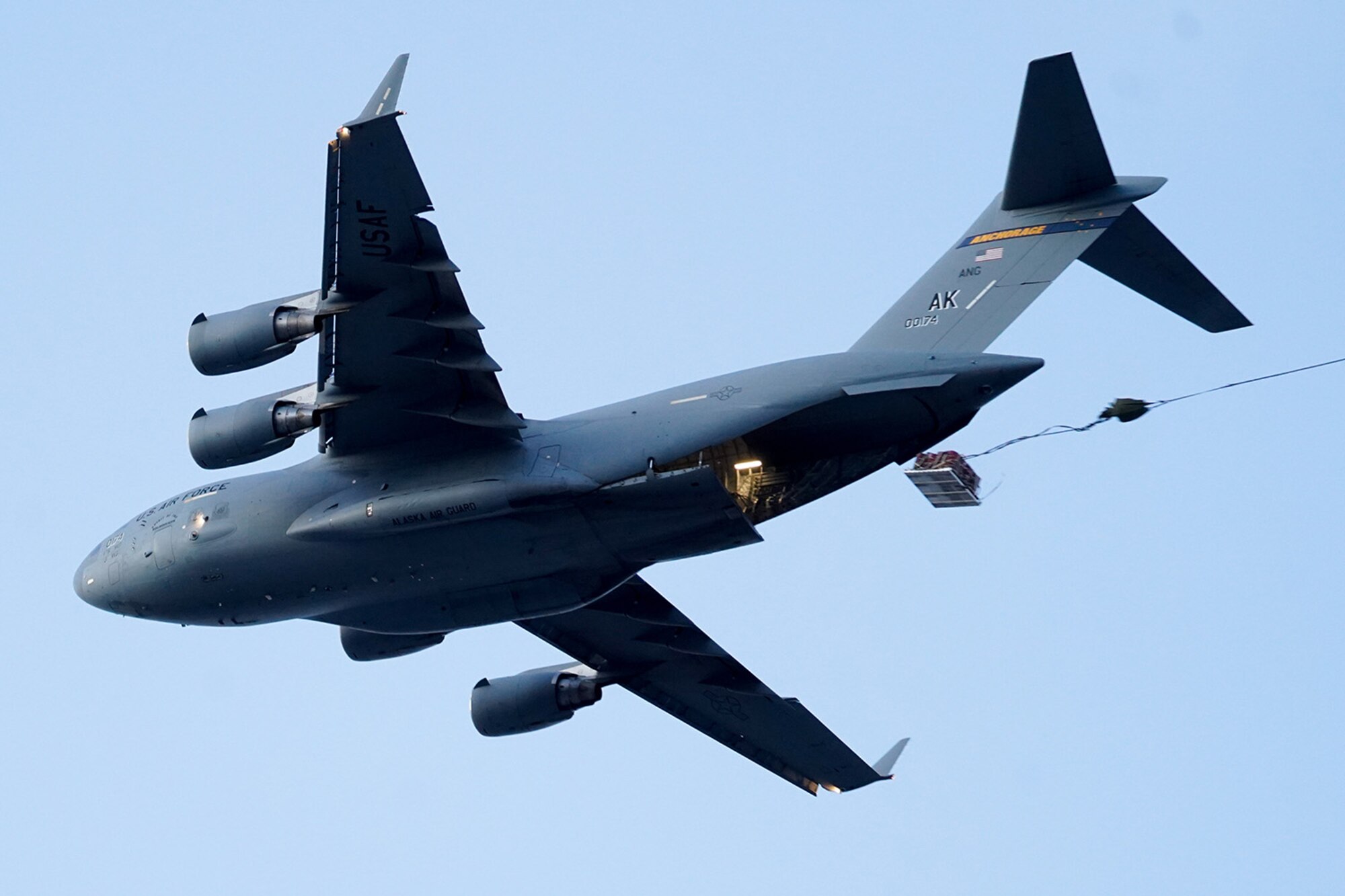 A C-17 Globemaster III drops heavy equipment before dropping paratroopers assigned to the 4th Infantry Brigade Combat Team (Airborne), 25th Infantry Division, U.S. Army Alaska, on Malemute drop zone at Joint Base Elmendorf-Richardson, Alaska, Dec. 11, 2019. The Soldiers are part of the Army’s only Pacific airborne brigade with the ability to rapidly deploy worldwide, and are trained to conduct military operations in austere conditions.