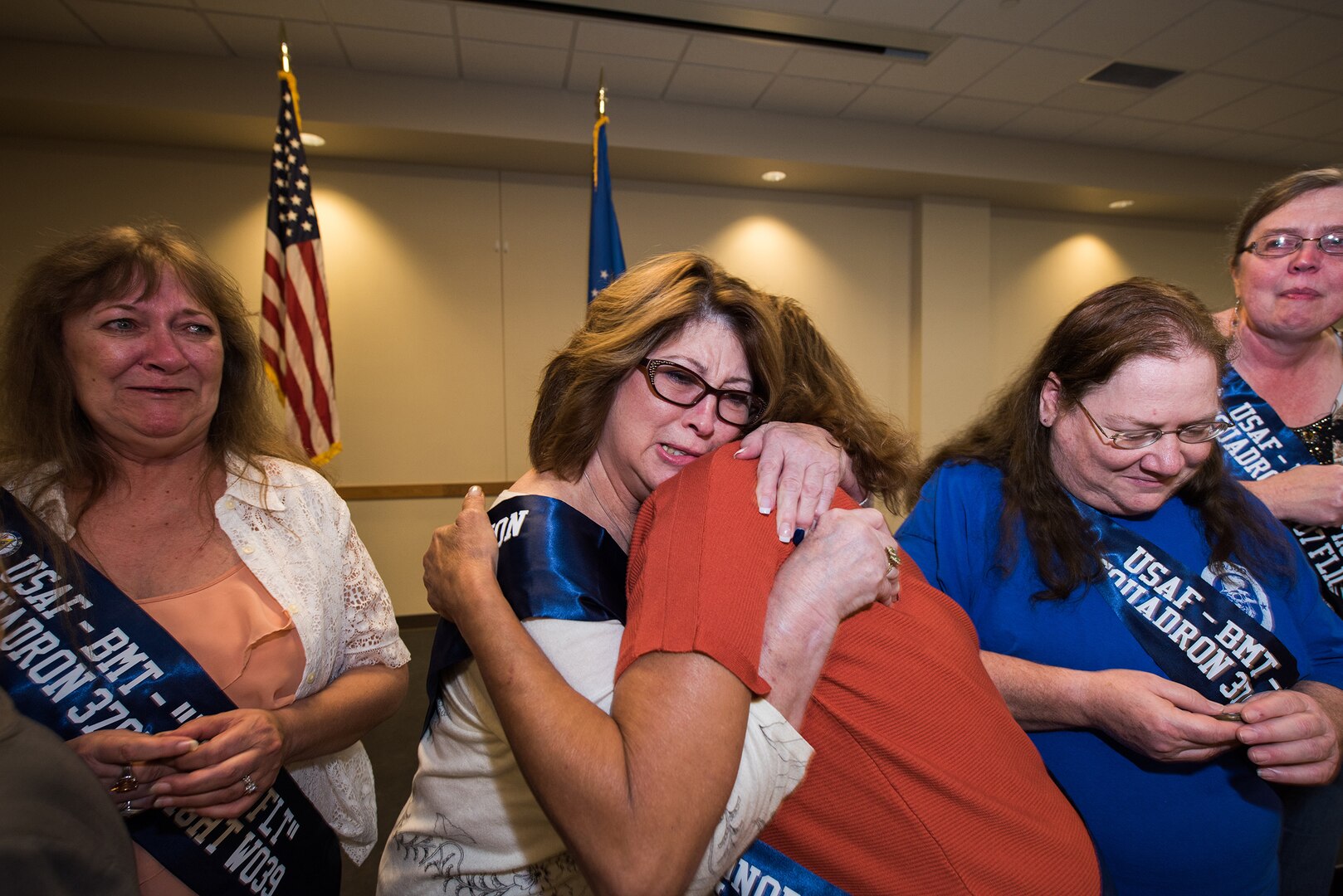 The women of flight W039, 3707th Squadron, of 1979, show tears of joy after receiving a coin, Oct. 18, 2019, at Joint Base San Antonio-Lackland, Texas.