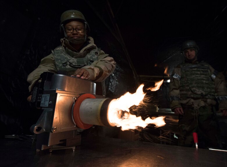 U.S. Air Force Senior Airman Kristen Floyd, 721st Force Support Squadron fitness apprentice, ignites a cooking heater from a single pallet expeditionary kitchen during Exercise Operation Varsity 19-04 at Ramstein Air Base, Germany, Dec. 11, 2019. A SPEK is a field kitchen designed be quickly assembled and support 550 personnel daily with three hot meals. Scenarios where a SPEK could be useful are in a remote location, during beddown of initial forces or when a permanent kitchen is damamged or cannot be accessed due to operations.
