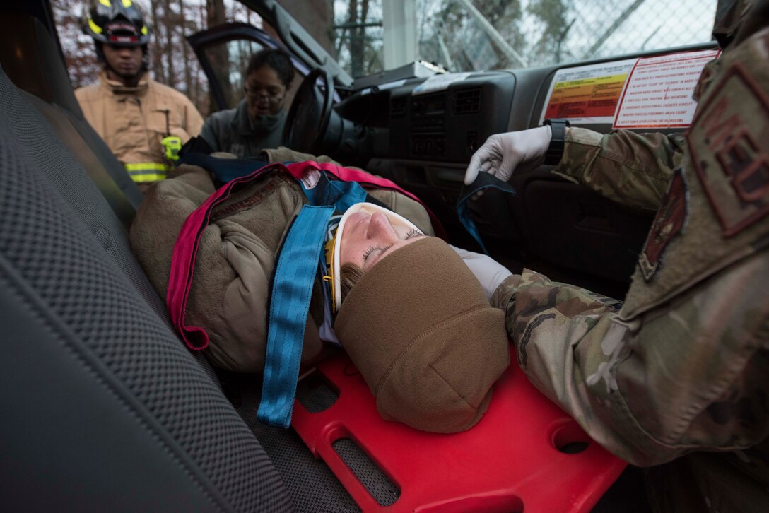 U.S. Air Force Master Sgt. Ryann Siedzek, 86th Medical Squadron radiology technician, plays the role of a car crash victim during Exercise Operation Varsity 19-04 at Ramstein Air Base, Germany, Dec. 12, 2019. After receiving a mock distress-call from Siedzek, the 86th Security Forces squadron followed their trianing by responding to the scene and contacting the 86th Medical Group and 86th Civil Engineer firefighters.