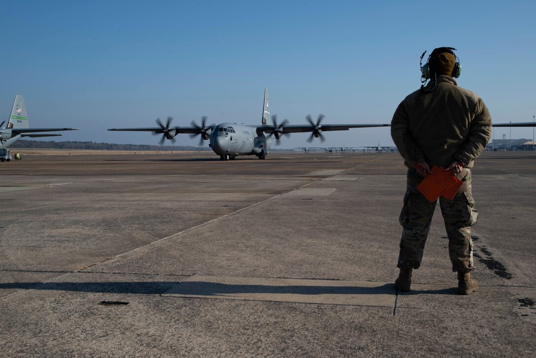 U.S. Air Force Reserve Staff Sgt. Fadarious Woods, 913th Maintenance Squadron maintainer, marshals an aircraft out of a parking ramp prior to takeoff on Dec. 7, 2019, at Little Rock Air Force Base, Ark. Aircraft maintainers perform flight safety and function checks on aircraft before and after each flight. Maintenance personnel ensure every part of these high-performance aircraft is ready to accomplish the mission. (U.S. Air Force photo by Senior Airman Chase Cannon)