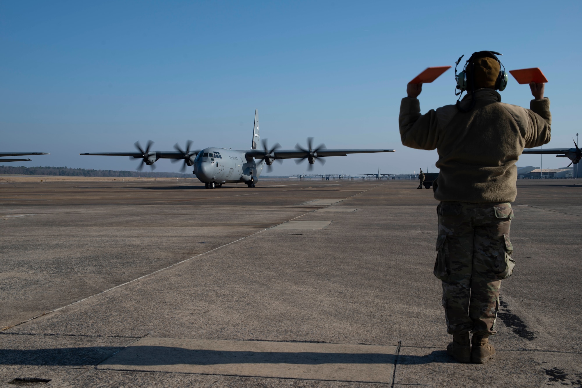 U.S. Air Force Reserve Staff Sgt. Fadarious Woods, 913th Maintenance Squadron maintainer, marshals an aircraft out of a parking ramp prior to takeoff on Dec. 7, 2019, at Little Rock Air Force Base, Ark. Aircraft maintainers perform flight safety and function checks on aircraft before and after each flight. Maintenance personnel ensure every part of these high-performance aircraft is ready to accomplish the mission. (U.S. Air Force photo by Senior Airman Chase Cannon)