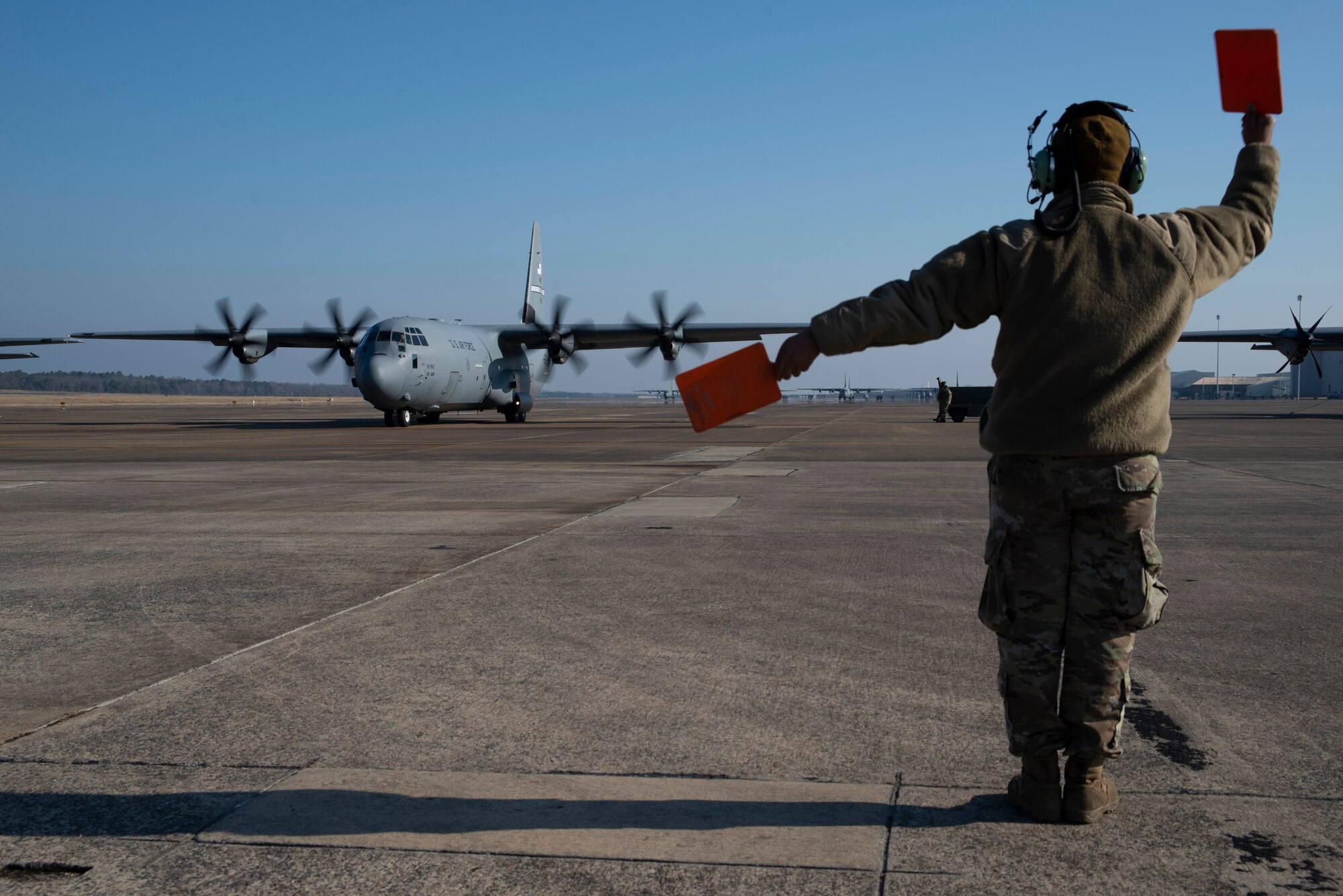 U.S. Air Force Reserve Staff Sgt. Fadarious Woods, 913th Maintenance Squadron maintainer, marshals an aircraft out of a parking ramp prior to takeoff on Dec. 7, 2019, at Little Rock Air Force Base, Ark. Aircraft maintainers perform flight safety and function checks on aircraft before and after each flight. Maintenance personnel ensure every part of these high-performance aircraft is ready to accomplish the mission. (U.S. Air Force photo by Senior Airman Chase Cannon)