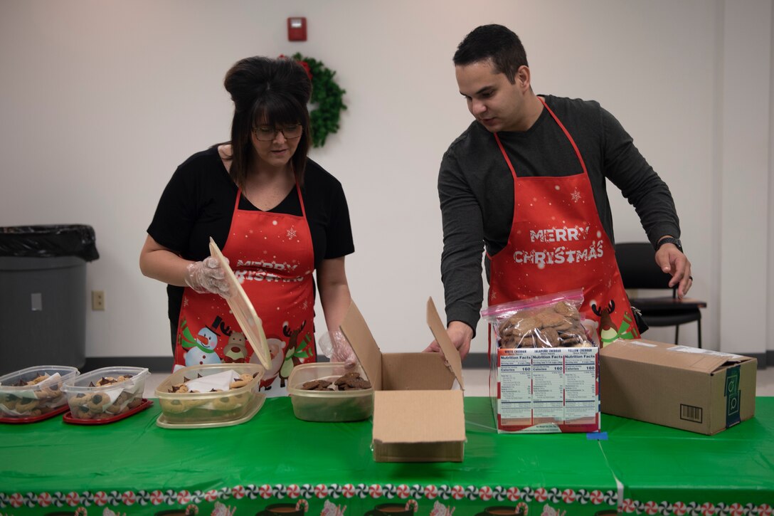 A photo of volunteers of the Moody Air Force Base Airmen Cookie Drive preparing to pack cookies.