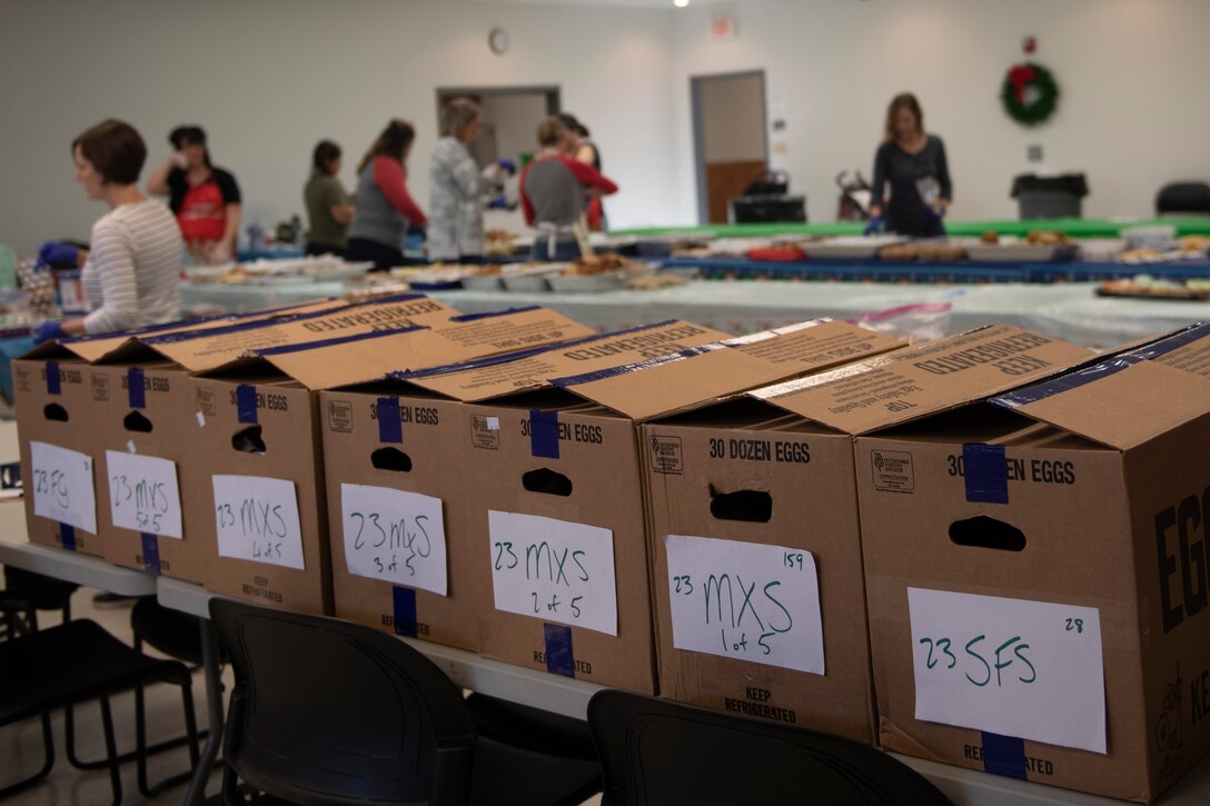 A photo of volunteers of the Moody Air Force Base Airmen Cookie Drive finishing packing cookies.