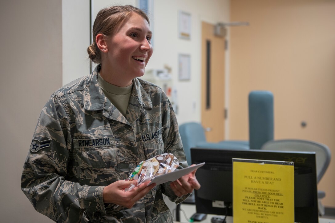 A photo of an Airman receiving cookies.