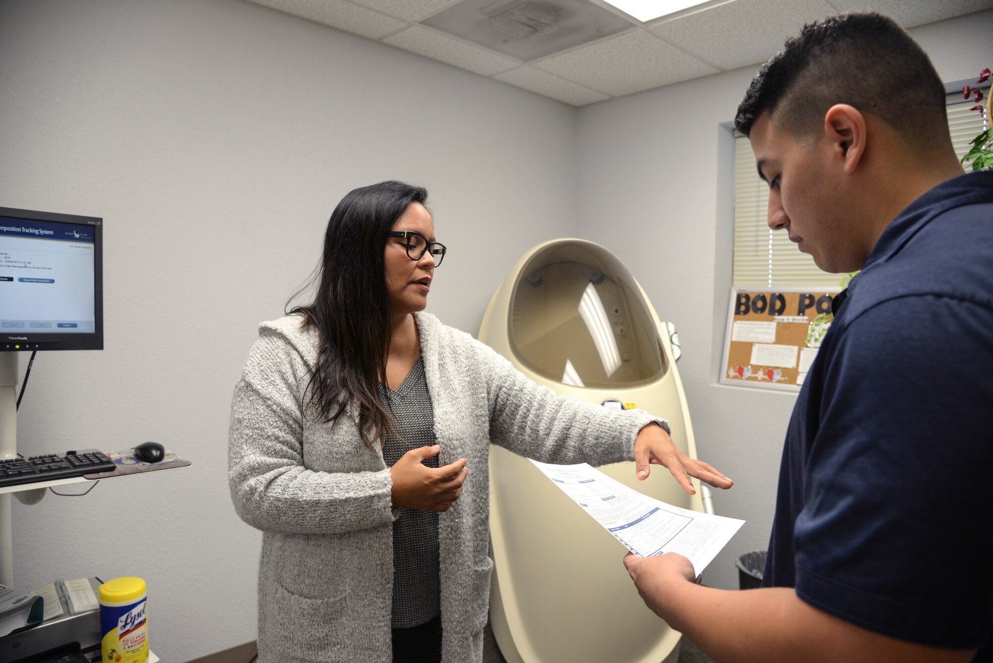 Photo of two people going over a result sheet.