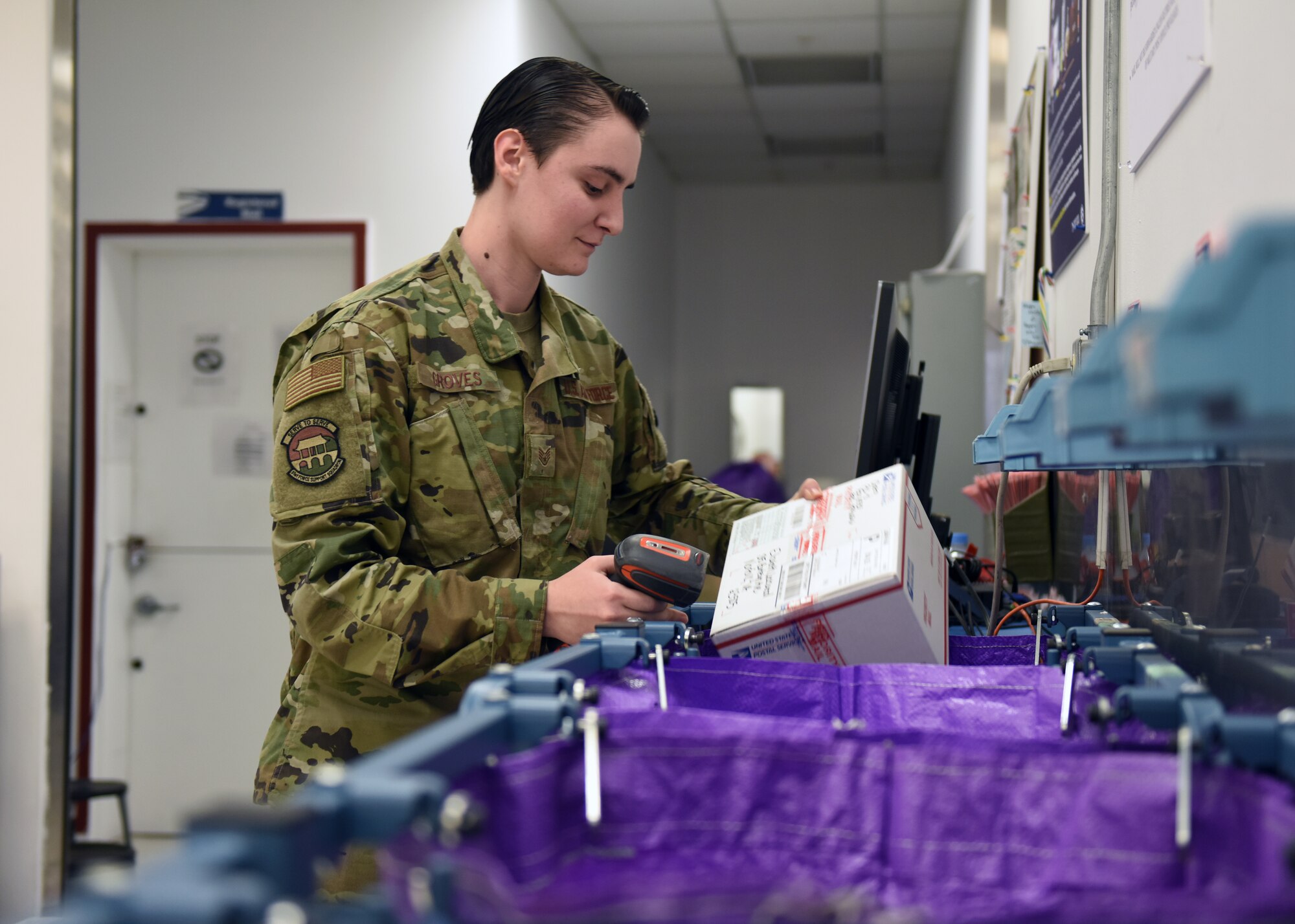 Staff Sgt. Danielle Groves, 51st Force Support Squadron post office financial services center noncommissioned officer in charge, sorts outgoing mail at the post office on Osan Air Base, Republic of Korea, Dec. 11, 2019. During the holiday season, the amount of mail coming through the post office is increased significantly. (U.S. Air Force photo by Senior Airman Denise Jenson)