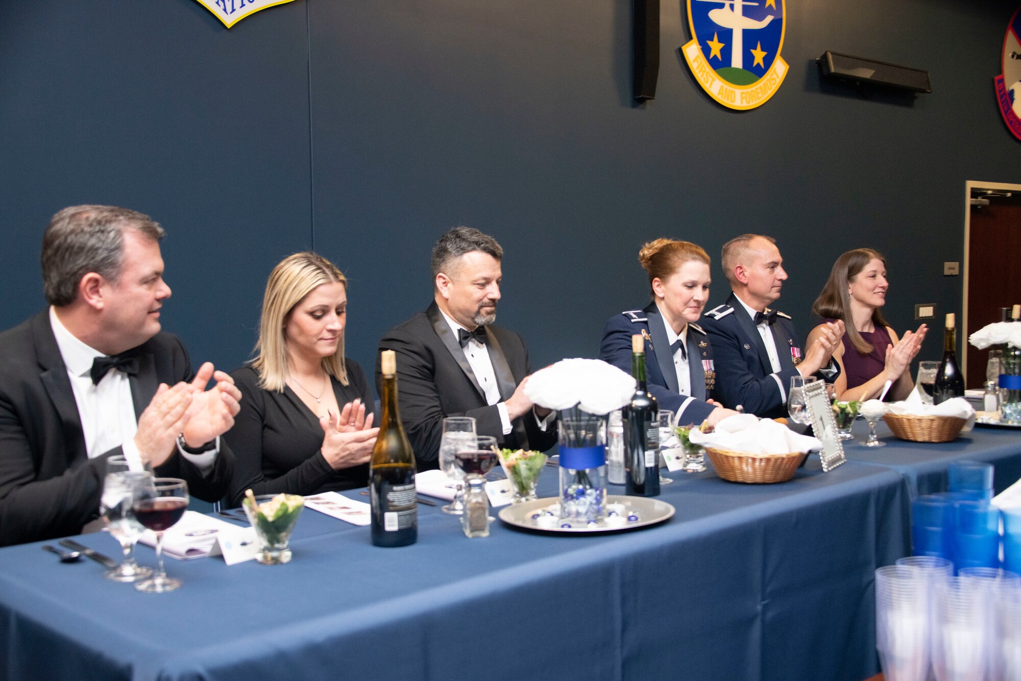 Distinguished guests clap for the introduction of the mess president, Air Force Col. Anne-Marie Contreras, 811th Operations Group commander, during the 1st Helicopter Squadron's 50th anniversary gala at Joint Base Andrews, Md., Dec. 6, 2019.