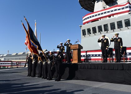 Japan (Dec. 12, 2019) The official party renders a hand salute as colors are paraded during the U.S. 7th Fleet flagship USS Blue Ridge (LCC 19) change of command ceremony. Capt. Craig C. Sicola, of Dallas, relieved Capt. Eric J. Anduze, from Manati, Puerto Rico, as the ship's commanding officer. Blue Ridge, a part of Expeditionary Strike Group 7, is the oldest operational ship in the Navy and, as 7th Fleet command ship, actively works to foster relationships with allies and partners in support of security and stability within the Indo-Pacific Region.
