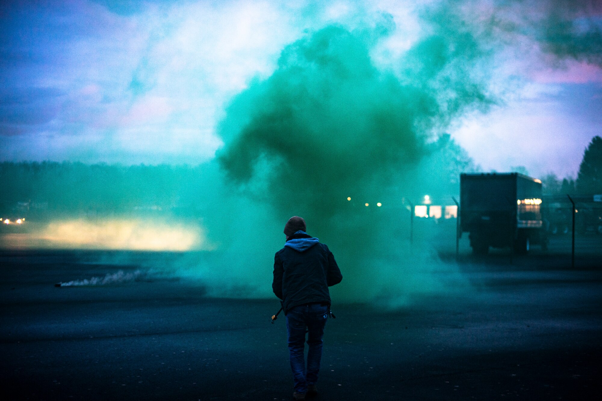 A U.S. Air Force Airman assigned to the 86th Airlift Wing Opposing Forces team advances on 569th U.S. Forces Police Squadron members during a simulated ground attack as part of exercise Operation Varsity 19-04 at Kapaun Air Station, Germany, Dec. 11, 2019. The simulation included the use of smoke grenades, blank rounds, and various assault rifles to enhance the realism of the exercise. (U.S. Air Force photo by Staff Sgt. Devin Boyer)
