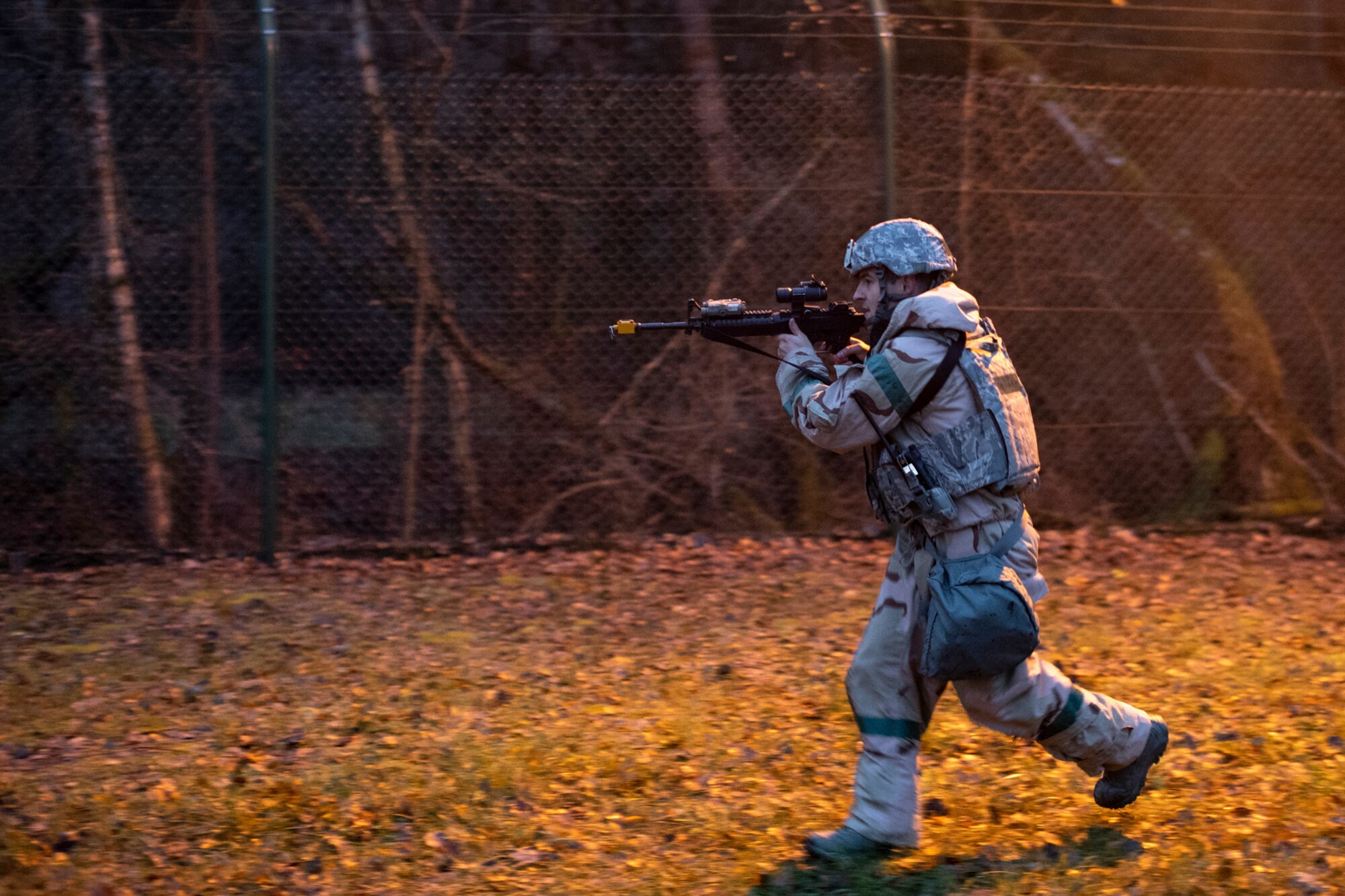 A U.S. Air Force Airman assigned to the 569th U.S. Forces Police Squadron advances on hostiles during a simulated ground attack as part of exercise Operation Varsity 19-04 at Kapaun Air Station, Germany, Dec. 11, 2019. The defenders responded to the simulated attack and applied their proficiencies to neutralize the threat. (U.S. Air Force photo by Staff Sgt. Devin Boyer)