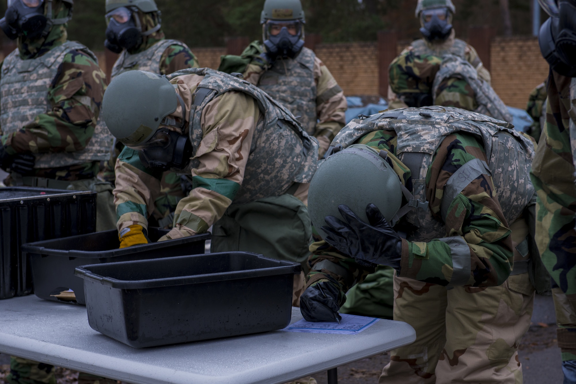 U.S. Air Force Airmen assigned to the 86th Airlift Wing prepare to go through a contamination control area during exercise Operation Varsity 19-04 at Ramstein Air Base, Germany, Dec. 11, 2019. The exercise enhances base readiness in response to explosive, chemical, biological, radiological and nuclear attacks. (U.S. Air Force Photo by Senior Airman Kaylea Berry)