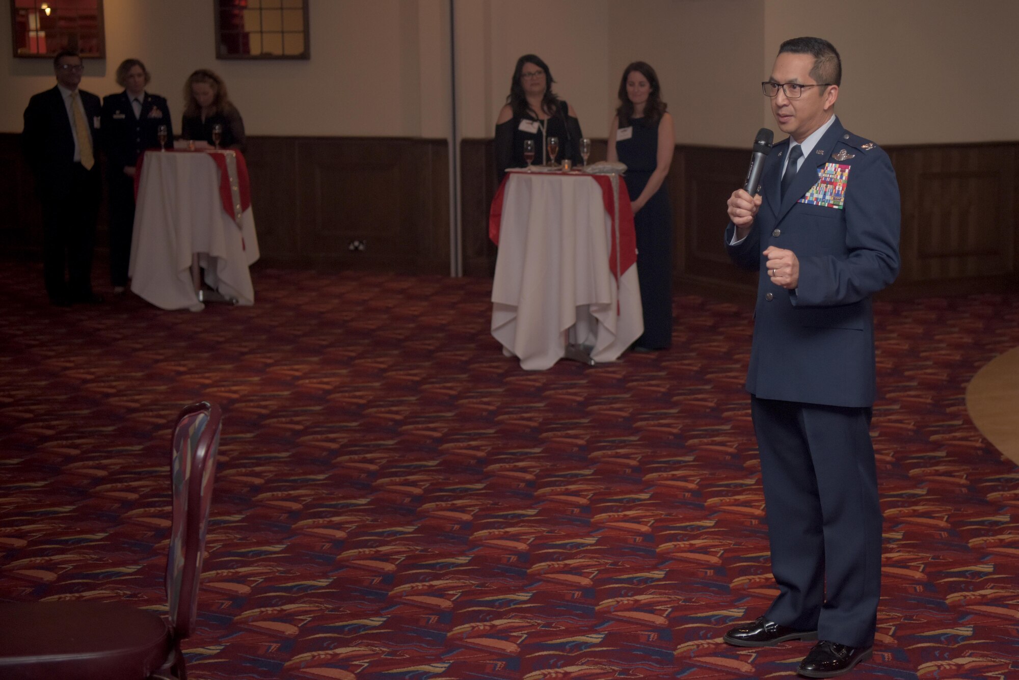 Col. Troy Pananon, 100th Air Refueling Wing commander, gives opening remarks to Airmen and community leaders during the 2019 Yuletide Reception at the Galaxy Club, RAF Mildenhall, Dec. 6, 2019. Events such as the Yuletide reception help build trust and friendship between the the U.S. military and  local leaders  who represent their communities. (U.S. Air Force photo by Senior Airman Benjamin Cooper)