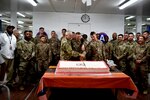 U.S. Army Col. Robert Bumgardner, commander of the 30th Armored Brigade Combat Team, North Carolina Army National Guard, is flanked by the youngest Soldier and most senior Soldier in the ranks for a cake-cutting ceremony in honor of the National Guard's 383rd birthday, at Camp Buehring, Kuwait, Dec. 13, 2019. Joining Bumgardner were Pfc. Charlie Christie, of the Ohio Army National Guard’s 145th Armor Regiment, and Chaplain Maj. William Withers of the 236th Brigade Engineer Battalion, North Carolina Army National Guard. The unit is deployed in the Middle East to support Operation Spartan Shield.