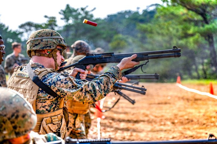 U.S. Marine Corps Lance Cpl. Declan N. Kellogg, an engineer equipment mechanic with 3rd Maintenance Battalion shoots the M1014 shotgun during the Security Augmentation Force Training from Dec. 12.