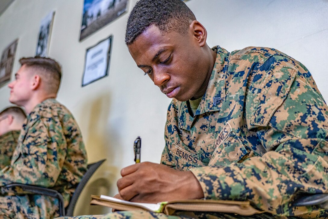 U.S. Marine Corps Cpl. Burnell K. Bemiss, a bulk fuel specialist with Marine Wing Support Squadron 172, takes notes during the Security Augmentation Force Training from Dec. 4.