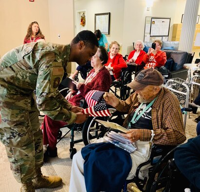 Members of the National Air and Space Intelligence Center volunteer at the Hospice of the Miami Valley on Veterans Day, Nov. 11, 2019. During the day, a team of nearly 15 service members read an oath of service, rendered a courtesy salute to the veterans and honored them for serving the United States.  The event concluded with a medal pinning, awarding of a certificate of appreciation and an American Flag presented to each veteran in hospice care. (U.S. Air Force courtesy photo)