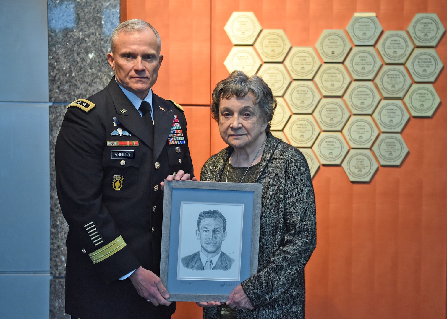 Defense Intelligence Agency Director Lt. Gen. Robert Ashley Jr., presents Dr. Blanka Shadrin a drawing of her husband, Nicholas Shadrin, after unveiling his plaque on the DIA Patriots Memorial. After defecting from the Soviet Union, Nicholas Shadrin worked at DIA while also serving as a double agent for the FBI. On a mission in Vienna in 1975, Shadrin was abducted by the KGB and killed from a sedative overdose.