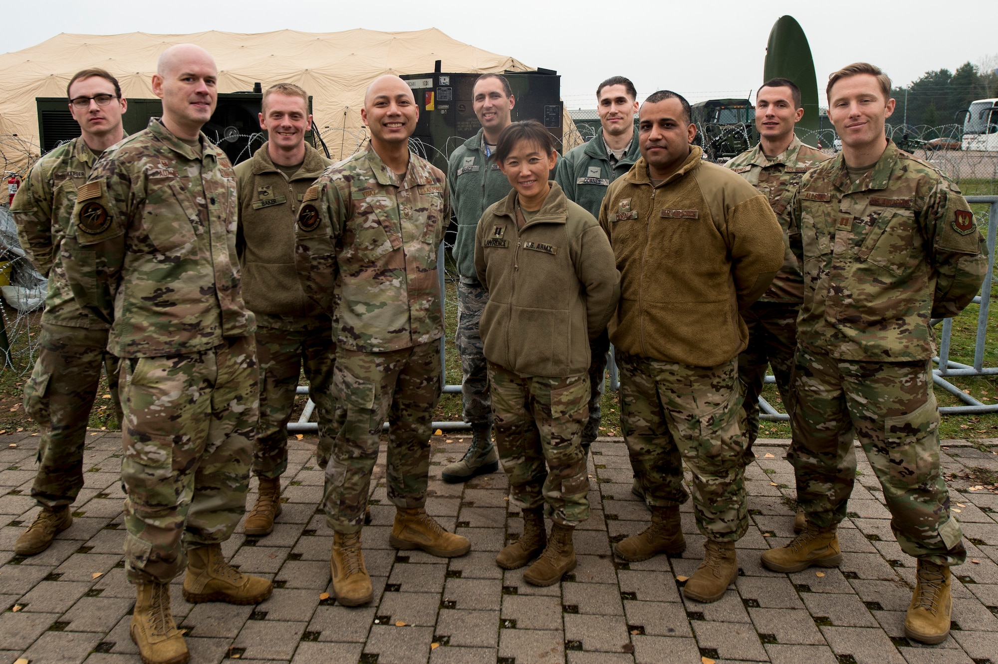 U.S. Airmen assigned to the 1st Air and Space Communications Operations Squadron and U.S. Soldiers assigned to the 66th Military Intelligence Brigade (Theater) pose for a group photo during Exercise Wild Card Straight on Rhine Ordnance Barracks, Germany, Nov. 21, 2019. During Wild Card Straight, Airmen and Soldiers practiced their ability to establish communications equipment and Intelligence, Surveillance and Reconnaissance operations in preparation for Exercise Juniper Cobra 20. Juniper Cobra 20 is a coalition exercise in Israel, June 2020. (U.S. Air Force photo by Staff Sgt. Jonathan Bass)