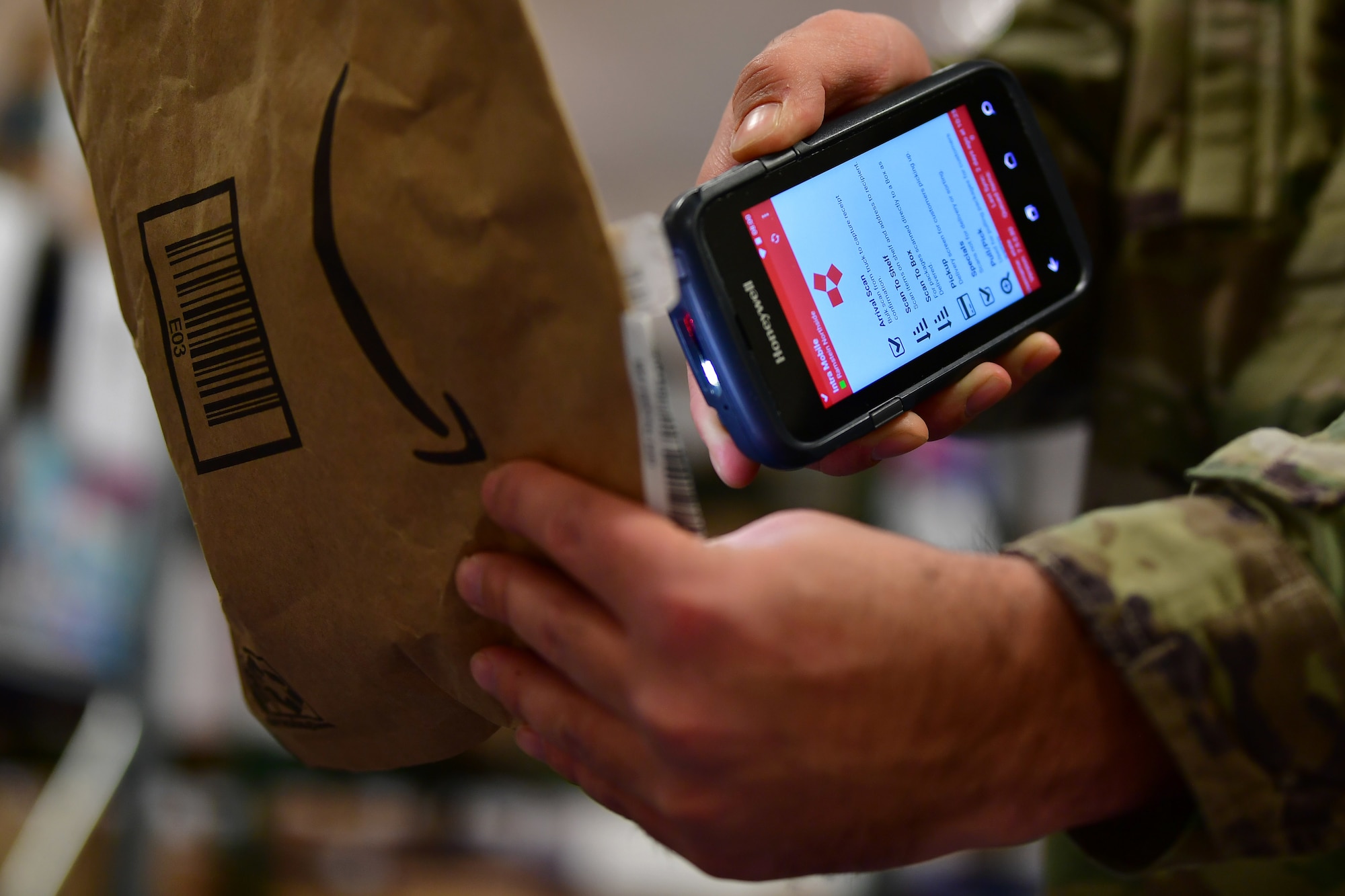 U.S. Air Force Staff Sgt. Thomas A. Bonelli, 786th Force Support Squadron postal service center noncommissioned officer in charge, scans a package into the electronic email notification system at the Northside Post Office, Ramstein Air Base, Germany, Dec. 6, 2019.
