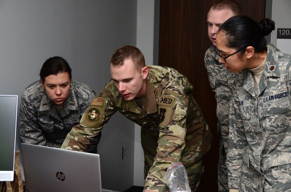 445th Aeromedical Staging Squadron Airmen run tests on a SimMan ALS manikin, Nov. 2, 2019. These ASTS members will become the training cadre for the medical technicians and nurses from all three medical units at the 445th Airlift Wing; 445th ASTS, 445th Aeromedical Evacuation Squadron and 445th Aerospace Medicine Squadron. The manikin’s advanced construction and computer systems allows the cadre to simulate illnesses for those training to identify and treat. ASTS was designated as the keeper of the $45,000 manikin.