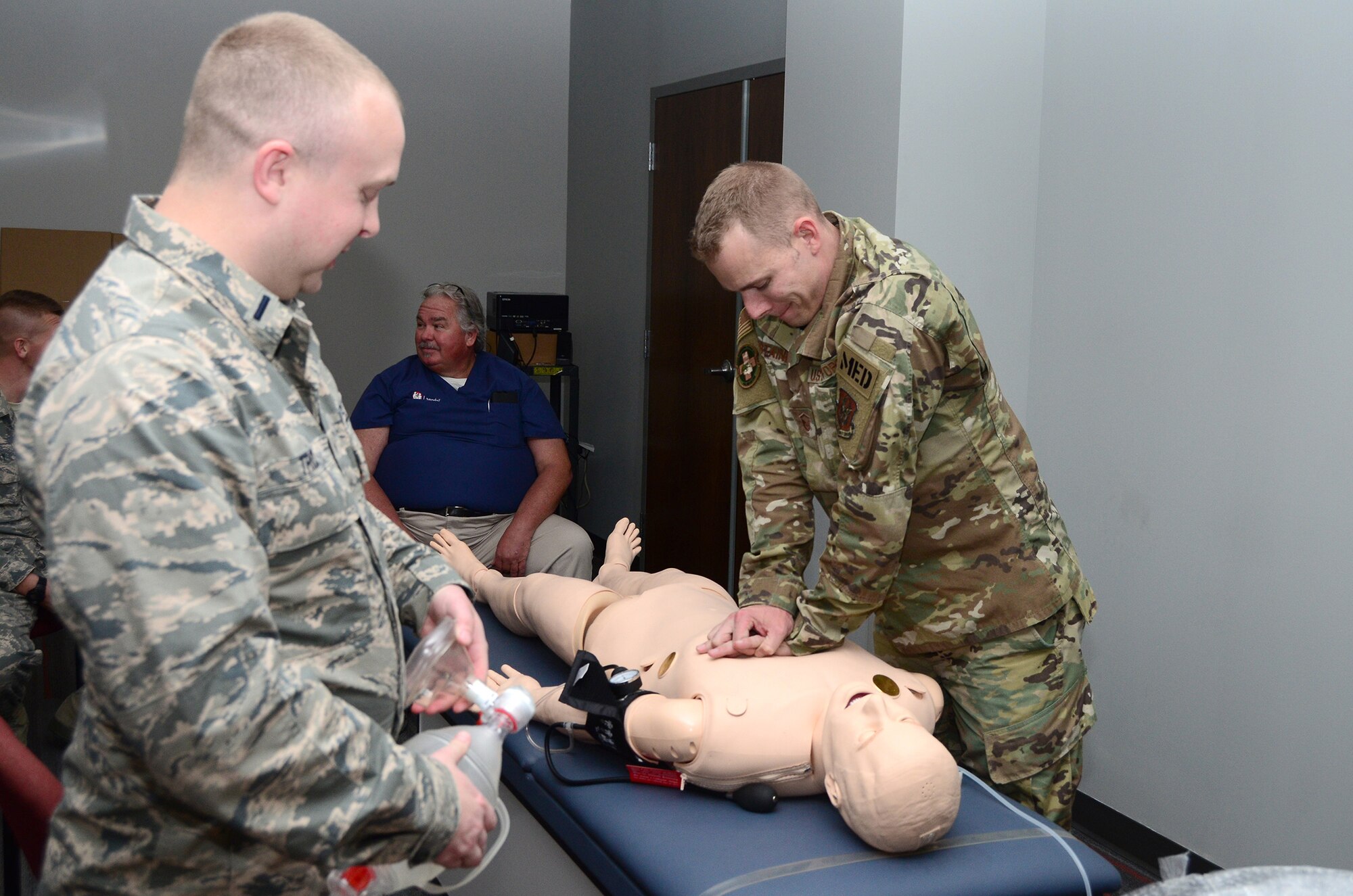 Master Sgt. Zachary Fontaine, 445th Aeromedical Staging Squadron medical technician performs chest compressions on a SimMan ALS manikin while 1st Lt. Ben Trick, ASTS, clinical nurse observes Nov. 2, 2019. The manikin provides feedback to cadre if the med. tech giving care is doing the compressions deep enough. Real-time feedback allows trainers to make immediate correction to care technics so medical personnel train right the first time.