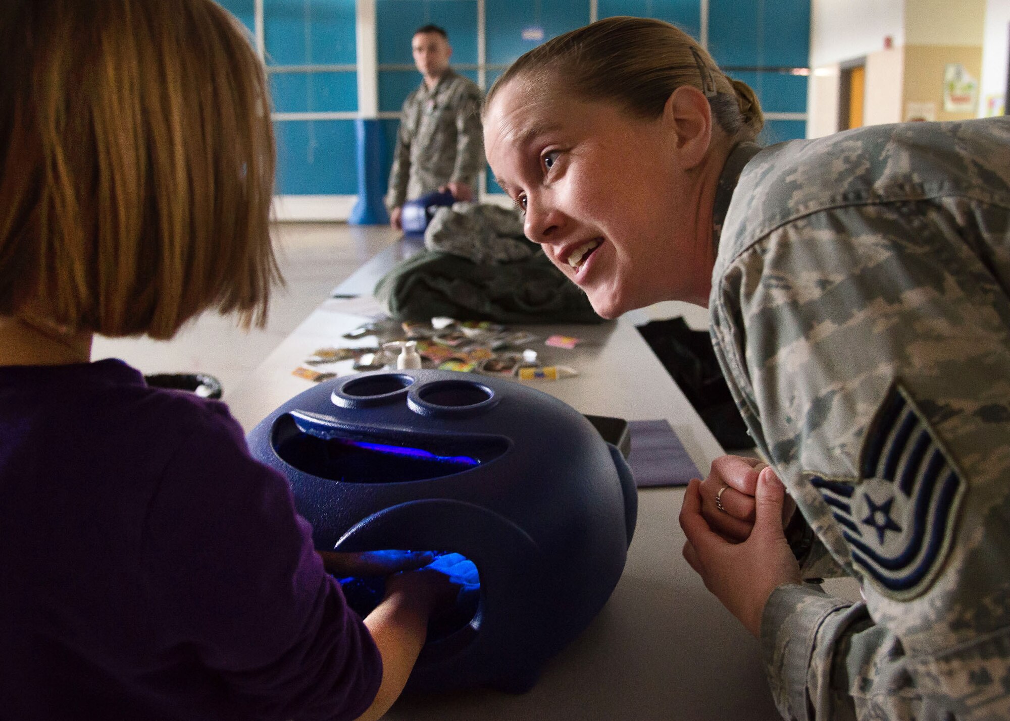 Tech. Sgt. Jennifer Maddox, 66th Medical Squadron Public Health technician, explains the importance of hand-washing to Emma Pottratz at the Hanscom Primary School April 5, 2016. Officials from the 66 MDS are encouraging the Hanscom community to practice thorough and regular hand washing to combat cold and flu season. (U.S. Air Force photo by Mark Herlihy)