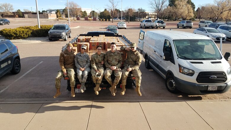 Members of the 21st Civil Engineer Squadron and Staff Sgt. Maria Martinelli pause before transporting a truckload of weeded-out books from base library on Peterson Air Force Base, Colorado on Nov. 13, 2019. The Airmen later drove the truck to the Defense Reutilization and Marketing Office on Fort Carson, Colorado. (U.S. Air Force courtesy photo)