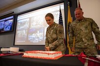 U.S. Army Lt. Col. Jennifer Green, a member of Joint Task Force Civil Support’s (JTF-CS) J5 directorate, and JTF-CS Command Senior Enlisted Leader U.S. Air Force Chief Master Sgt. James Brown participate in a cake cutting to commemorate the U.S. National Guard’s 383rd birthday. (DoD Photo by Chief Mass Communication Specialist Barry Riley/RELEASED)