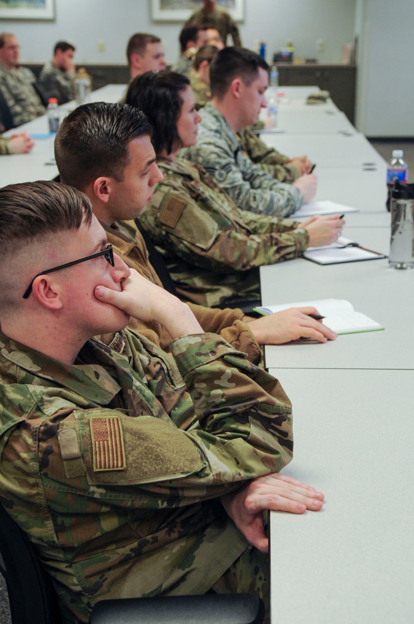 Senior Airman Christopher Shover, National Air and Space Intelligence Center, Special Missions Division knowledge manager, listens to a briefing during a First Sergeant’s Panel on the progressive discipline model at Wright-Patterson Air Force Base, Ohio, Dec. 11, 2019. During the panel, First Sergeants discussed the progressive discipline model and different methods for mentoring subordinates. (U.S. Air Force photo by Staff Sgt. Seth Stang)
