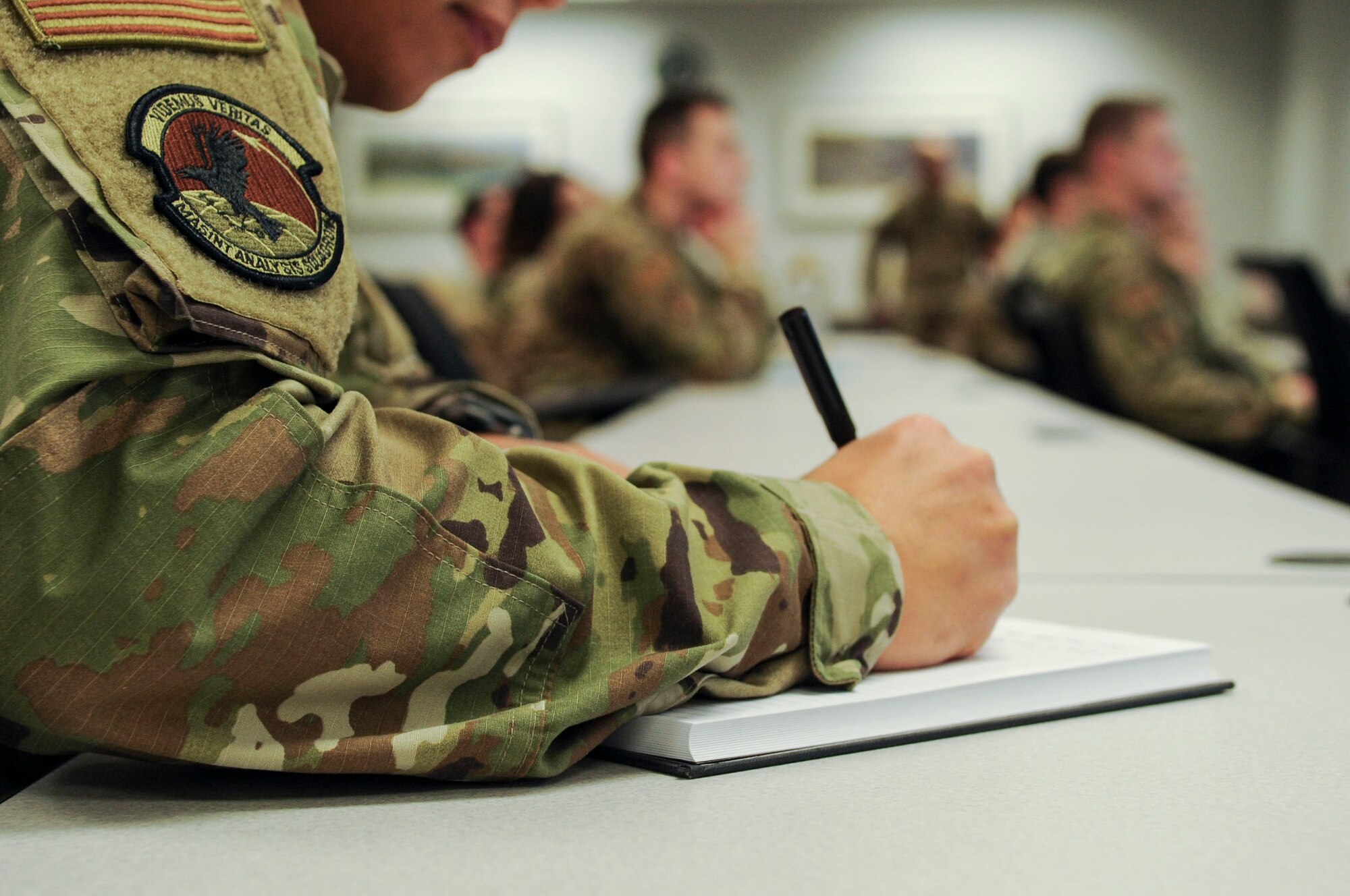 1st Lt. Enoc Flores, National Air and Space Intelligence Center, Measurement and Signature Intelligence Analysis Squadron executive officer, takes notes during a First Sergeant’s Panel on Wright-Patterson Air Force Base, Ohio, Dec. 11, 2019. This was the first time Flores had attended such an event, and he stated that he was interested in learning about the progressive discipline model and different supervisory methods. (U.S. Air Force photo by Staff Sgt. Seth Stang)